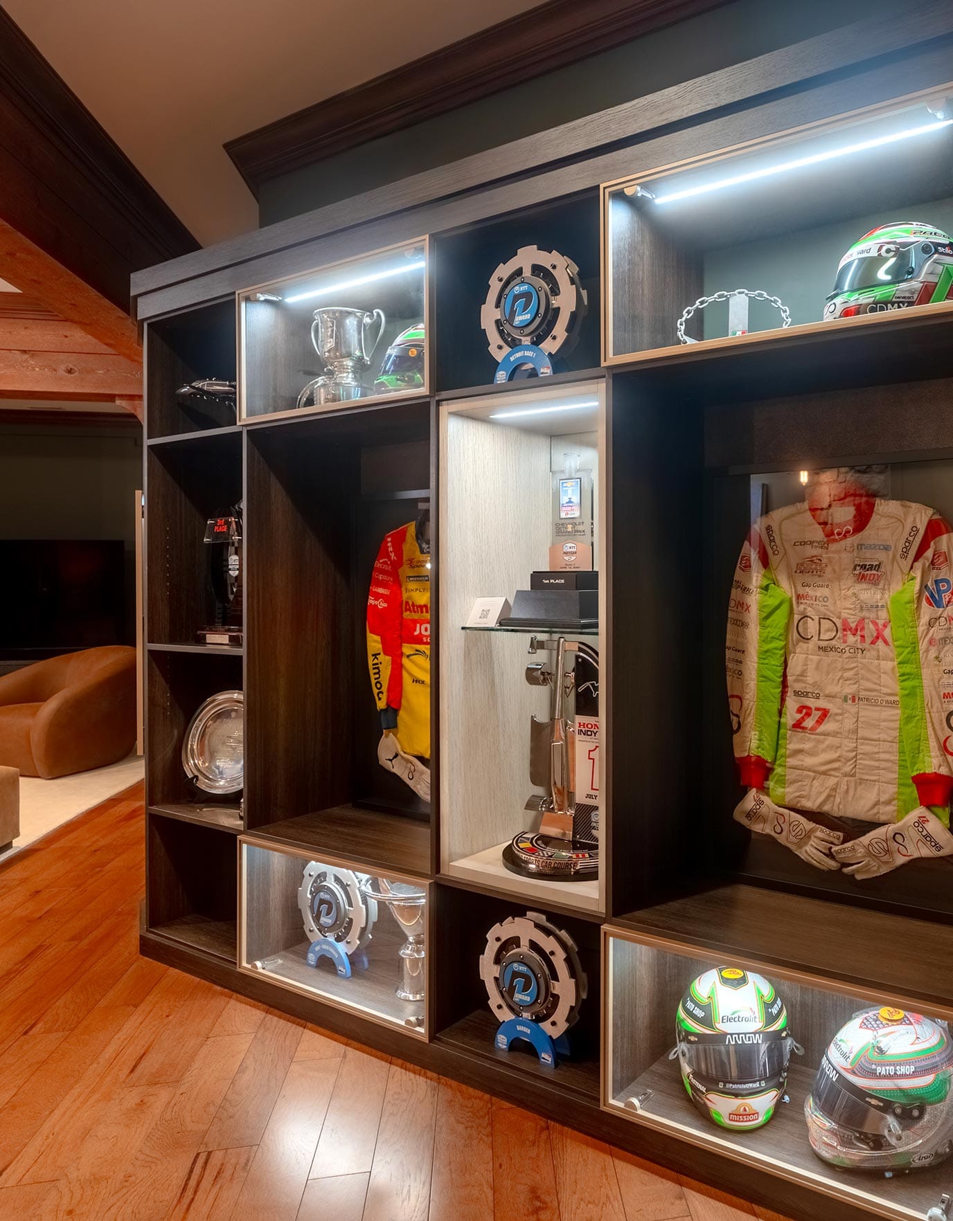 Pato O'Ward's various racing gear shown in custom built shelving and cubbies in his renovated basement from California Closets