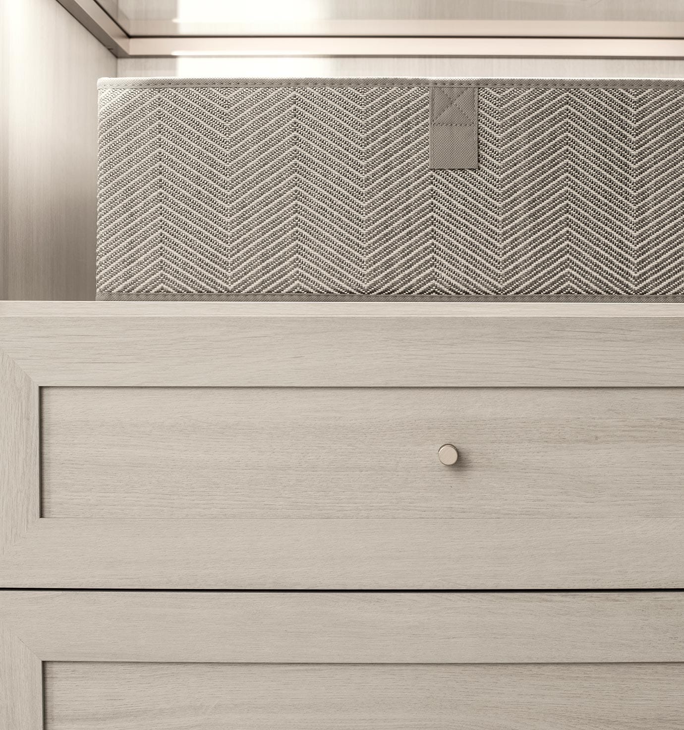 Customized cabinet drawers in a light grey finished by California Closets