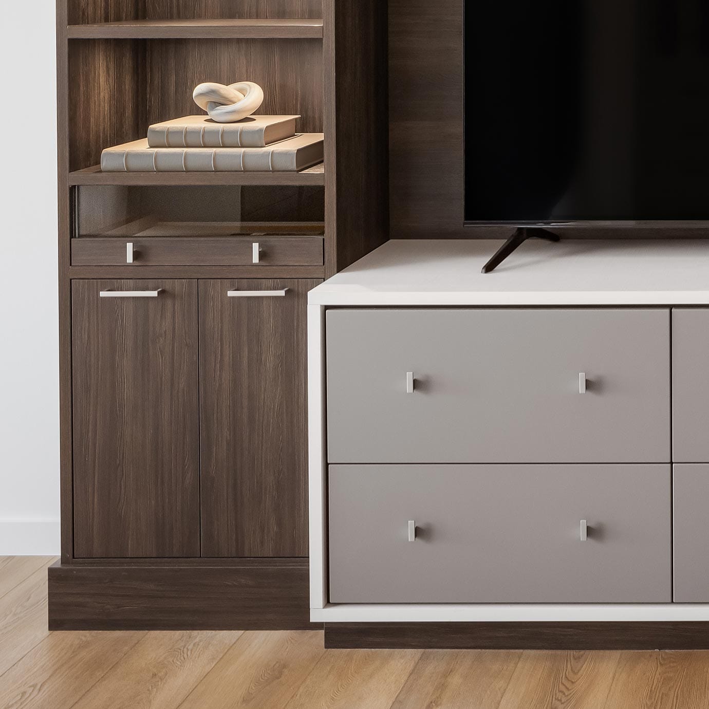 Storage drawers in custom media storage design with white, grey and dark wood finishes by California Closets
