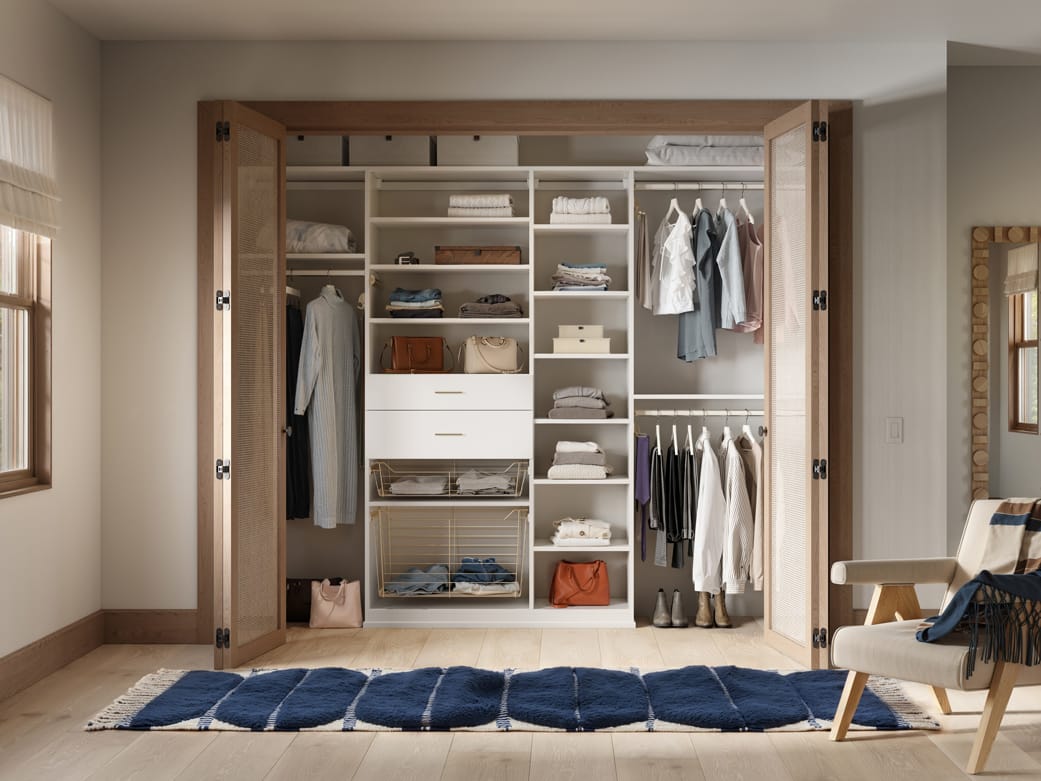 Designed with reach in closet and to-floor shelving, cubbies, and open shelving by California Closets