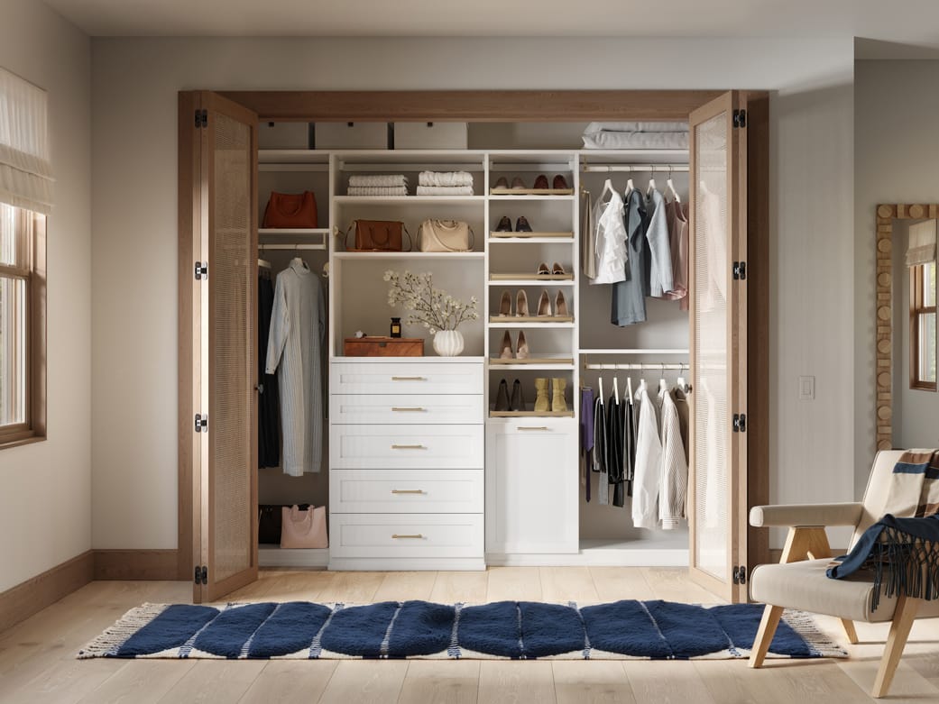 Custom closet system reach in design with tall shelving and shoe shelves by California Closets