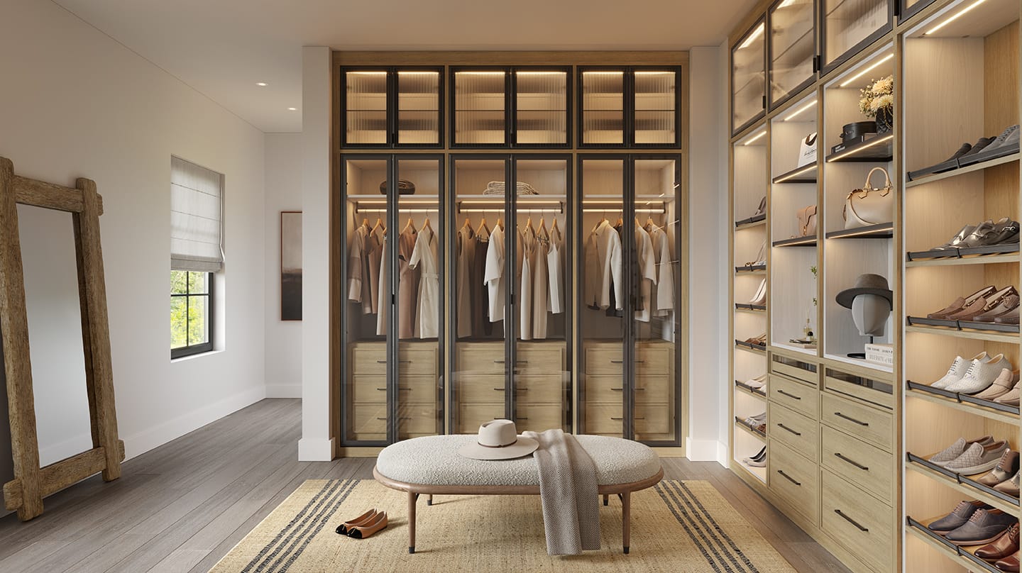 Walk-in design layout with custom open shelving, shoe walls, and LED lighting by California Closets