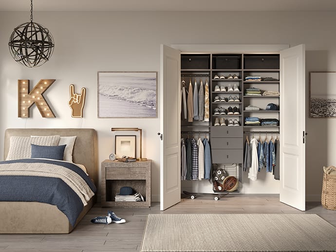 Custom kids closet with shoe storage, shelving, and drawers in a gray finish by California Closets